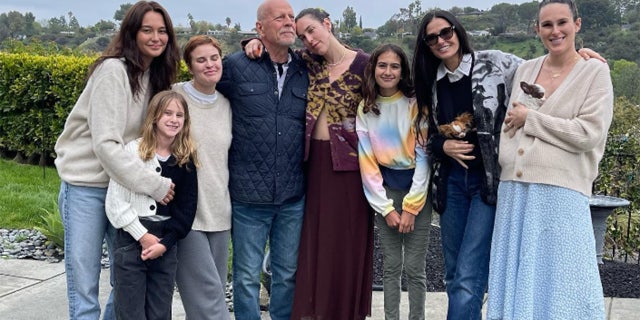 Bruce Willis, Emma Willis, Demi Moore and their children posing for a picture while celebrating his birthday