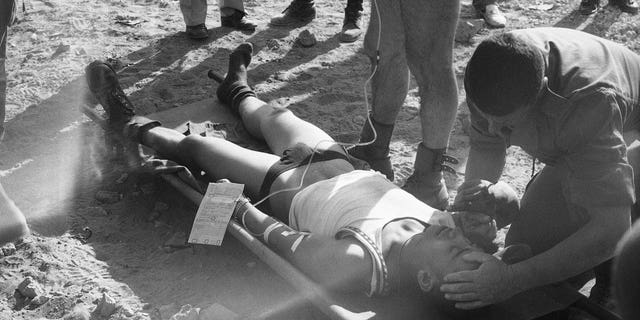 A wounded French soldier is attended to by a doctor after he was injured in a huge car bomb attack at a building housing members of the French contingent of the peacekeeping forces in Beirut, on Oct. 23, 1983. 