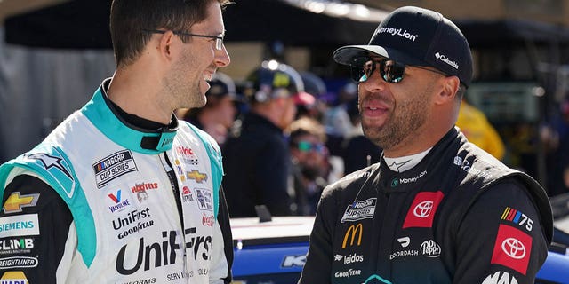 Mar 25, 2023; Austin, Texas, USA;  NASCAR Cup Series drivers Jordan Taylor (9) and Bubba Wallace (23) speak before qualifying at Circuit of the Americas.
