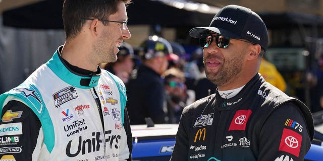 March 25, 2023;  Austin, Texas, United States;  NASCAR Cup Series drivers Jordan Taylor (9) and Bubba Wallace (23) speak before qualifying at the Circuit of the Americas.