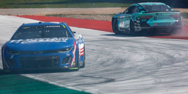 Bubba Wallace, driver of the #23 Toyota MoneyLion, and Kyle Larson, driver of the #5 HendrickCars.com Chevrolet, spin after an on-track incident during the NASCAR Cup Series EchoPark Automotive Grand Prix at the Circuit of the Americas on March 26, 2023 in Austin, Texas.