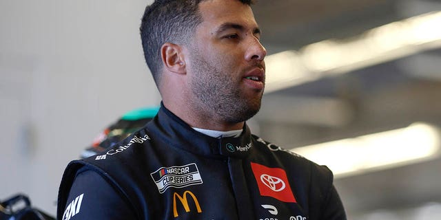Bubba Wallace, driver of the #23 Toyota MoneyLion, waits in the garage area during practice for the NASCAR Cup Series EchoPark Automotive Grand Prix at Circuit of the Americas on March 24, 2023 in Austin, Texas.