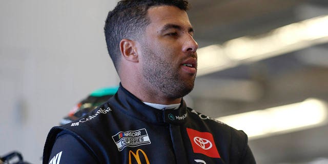 Bubba Wallace, driver of the #23 MoneyLion Toyota, waits in the garage area during practice for the NASCAR Cup Series EchoPark Automotive Grand Prix at Circuit of The Americas on March 24, 2023 in Austin, Texas.