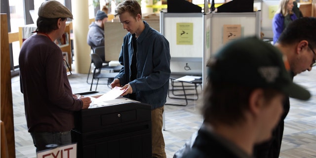 People vote at a polling place March 3, 2020, at Fletcher Free Library in Burlington, Vt.