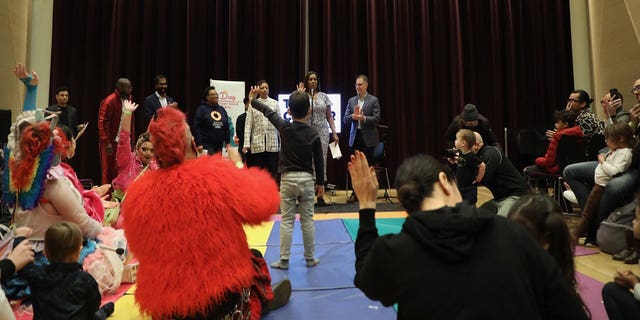 A child raises their hand during a New York City Drag Story Hour hosted by Attorney General Letitia James. 