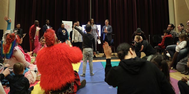 A child raises their hand during a New York City Drag Story Hour hosted by Attorney General Letitia James.