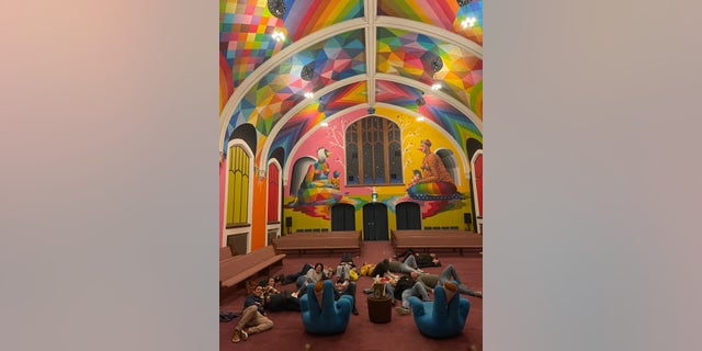 People lay on the floor inside the International Church of Cannabis. 