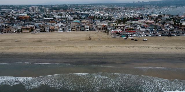 This aerial image taken with a drone, shows the closed beach after oil washed up in Newport Beach, California, on Oct. 7, 2021.