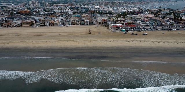 This aerial image taken with a drone, shows the closed beach after oil washed up in Newport Beach, California, on Oct. 7, 2021.