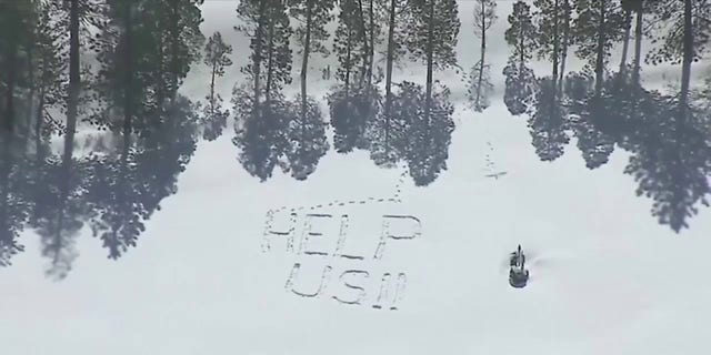 A California resident wrote "help us!!" in the snow Friday, March 3, 2023, in Crestline.
