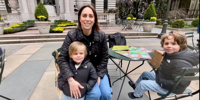 Ashley Burke, of Brooklyn, New York, attends a March 31, 2023 book read by Kirk Cameron at Bryant Park in New York City with her two children, Asher and Yehuda. "I'm only here to support Brave Books and Kirk Cameron's mission," Burke said.