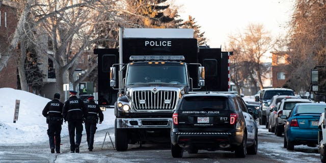 Police investigate the scene where two officers were shot and killed on duty in Edmonton on March 16, 2023.