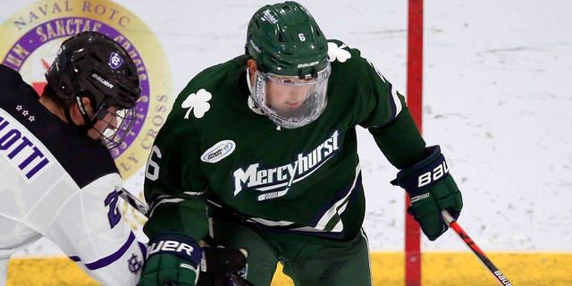 FILE - Holy Cross's Jack Robilotti (2) defends Mercyhurst's Carson Briere (6) during the first half of an NCAA hockey game on Friday, Nov. 12, 2021, in Worcester, Mass.
