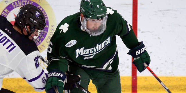 FILE - Holy Cross's Jack Robilotti (2) defends Mercyhurst's Carson Briere (6) during the first half of an NCAA hockey game on Friday, Nov. 12, 2021, in Worcester, Mass.