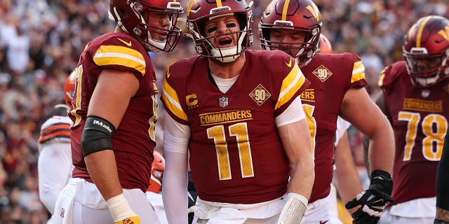 Carson Wentz of the Washington Commanders celebrates after scoring a touchdown against the Cleveland Browns on January 1, 2023 in Landover, Maryland.