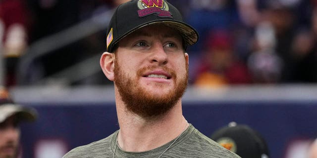 Carson Wentz of the Washington Commanders performs the national anthem before the Texans game at NRG Stadium on November 20, 2022 in Houston.
