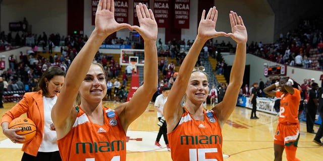 Haley Cavinder, #14, and Hanna Cavinder, #15, of Miami, celebrate after Miami defeated Indiana in a second round college basketball game in the NCAA Women's Tournament on Monday, March 20, 2023, in Bloomington , Indiana.