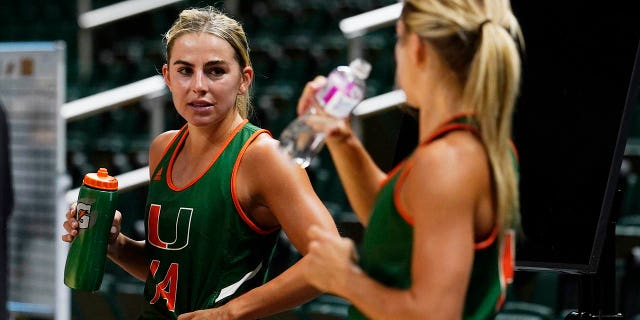 Miami NCAA college basketball guards and sisters Haley and Hannah Cavender take a break during practice Friday, October 7, 2022, in Coral Gables, Florida.