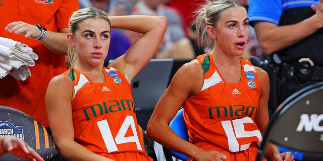 Haley Cavinder, #14, and Hanna Cavinder, #15 of the Miami Hurricanes sit on the bench during the second half against the Villanova Wildcats in the Sweet 16 round of the NCAA Women's Basketball Tournament in Bon Secours Wellness Arena on March 24, 2023 in Greenville, South Carolina.