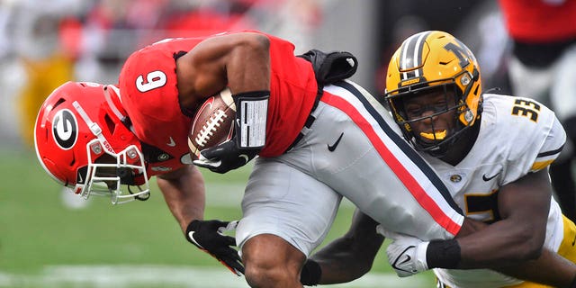 Missouri Tigers linebacker Chad Bailey, #33, wraps up Georgia Bulldogs running back Kenny McIntosh, #6, during the second quarter of a college football game between the Missouri Tigers and Georgia Bulldogs on Saturday, Nov. 6, 2021 at Sanford Stadium in Athens, Georgia.