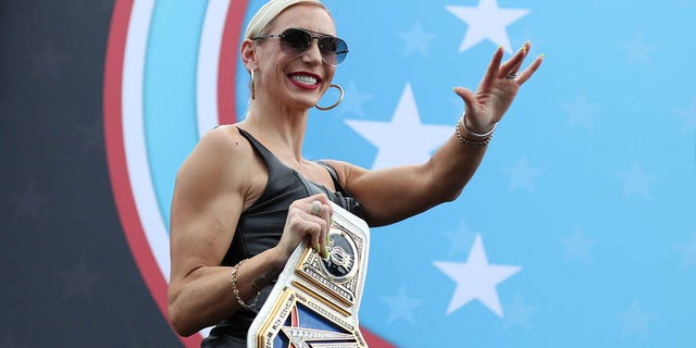 Smackdown Women's Champion Charlotte Flair takes the stage during pre-race ceremonies ahead of the 65th annual NASCAR Cup Series Daytona 500 at Daytona International Speedway on February 19, 2023 in Daytona Beach, Florida.