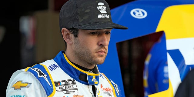 Chase Elliott watches as his crew works on his car during a practice for NASCAR's Daytona 500 Feb. 17, 2023, at Daytona International Speedway in Daytona Beach, Fla.