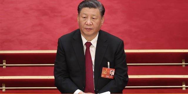 Chinese President Xi Jinping sitting at a session