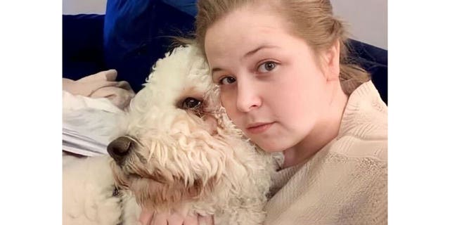 Ciera Breland holding her dog while taking a selfie. She was last seen leaving her mother-in-law's house with her husband and son on February 24 at Johns Creek, GA.