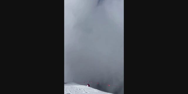 Snow fills the frame of the video as an avalanche hits the ridge