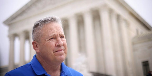 football coach Joe Kennedy in front of Supreme Court building