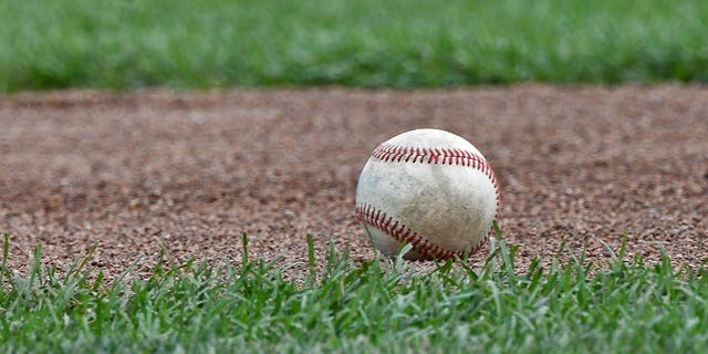 A baseball lies on the field.