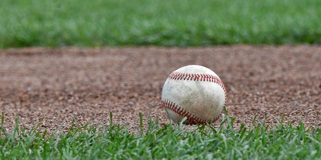 A baseball lays in the field