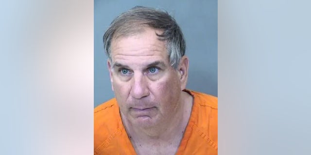 Michael Andre Colville, 61, allegedly attacked a woman at a Phoenix airport parking lot, asking her if she wanted to die, prosecutors said.