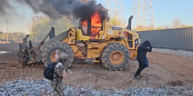 Protesters set construction equipment on fire at the site of a proposed police training facility in Atlanta.