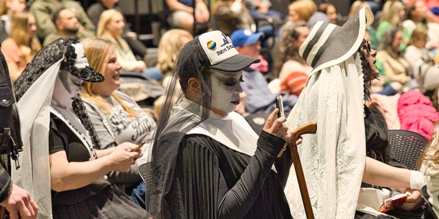 At Kirk Cameron's children's book reading event at the public library in Fayetteville, Arkansas, on Friday, March 17, some individuals dressed in black and white are shown seated with the crowd of about 500 parents and kids. 