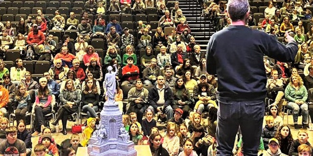 Kirk Cameron stands on stage and addresses the families and children assembled for a kids' book reading event in Fayetteville, Arkansas. About 500 or so people were in attendance, the publisher said.