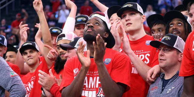 Arizona guard Courtney Ramey, center, celebrates with teammates after their victory over UCLA in an NCAA college basketball game for the Pac-12 Men's Tournament championship, Saturday, March 11, 2023, in Las Vegas.