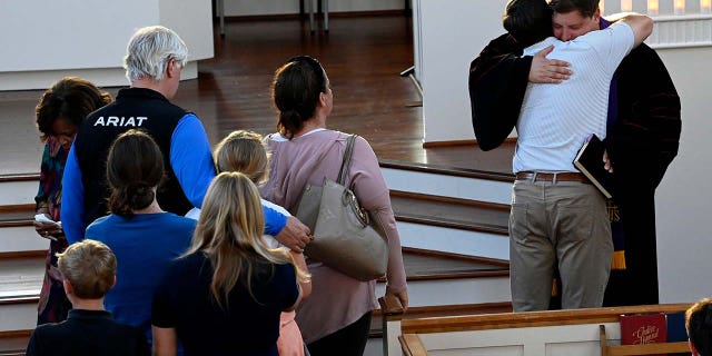 People comfort Woodmont Christian Church pastor Clay Stauffer after a prayer vigil for victims of the mass shooting at Covenant School on Monday, March 27, 2023, in Nashville.