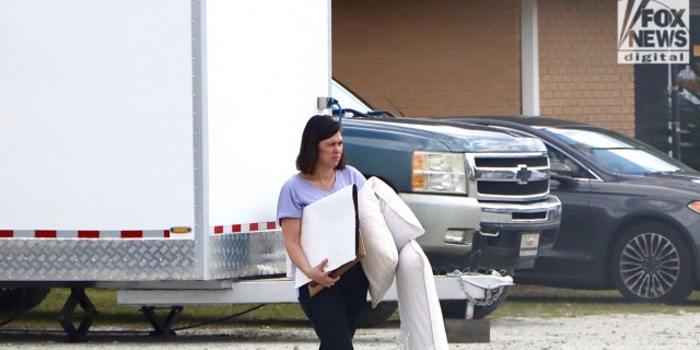 Christy Murdaugh, who is married to Alex Murdaugh's brother Randy, stopped by the auction house on Thursday morning to pick up several items, including Maggie Murdaugh's monogrammed pillows.