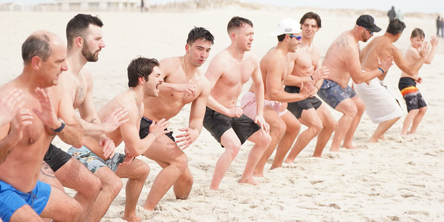 Cold plunge group "Sunday Swim" practices Wim Hof's horse stance to induce blood flow while gathered on Robert Moses beach on Long Island, New York, March 12, 2023.