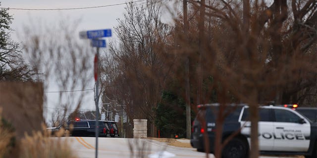 Police arrive at the scene of a burglary after neighbors reported a man wielding a makeshift knife.