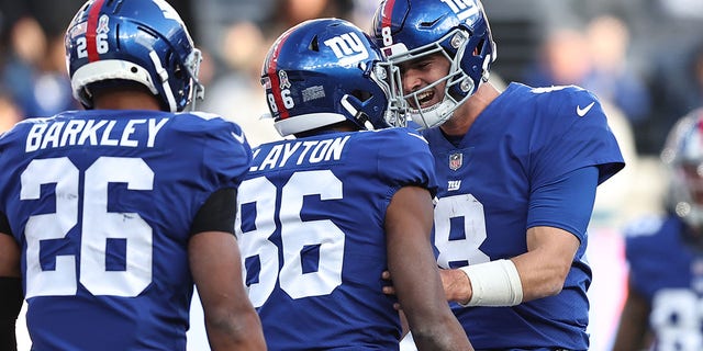 Daniel Jones #8 of the New York Giants congratulates Darius Slayton #86 after a touchdown during the third quarter in the game against the Houston Texans  at MetLife Stadium on November 13, 2022 in East Rutherford, New Jersey.