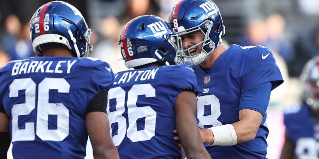Daniel Jones #8 of the New York Giants congratulates Darius Slayton #86 after a touchdown during the third quarter in the game against the Houston Texans at MetLife Stadium on November 13, 2022 in East Rutherford, New Jersey.