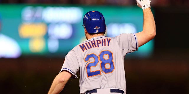 Daniel Murphy, No. 28 of the New York Mets, rounds the bases after hitting a home run with two during the fourth game of the 2015 MLB National League Championship Series at Wrigley Field against Fernando Rodney, No. 57 of the Chicago Cubs, in the eighth inning runs scored on October 21, 2015 in Chicago.