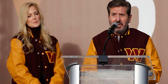 Washington Commanders co-owner Dan Snyder speaks as co-owner Tanya Snyder listens during a press conference revealing the Commanders as the new name of Washington's football team at FedEx Field in Landover, Md., Feb 2, 2022.