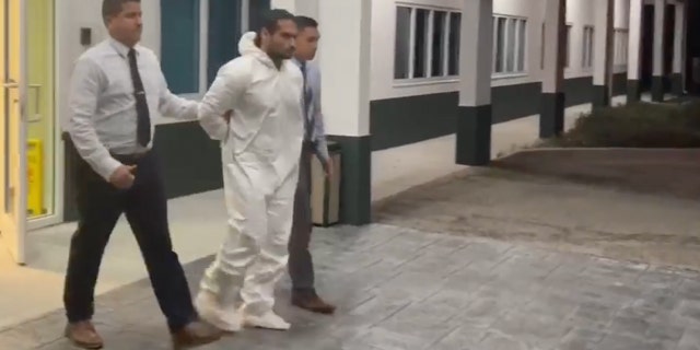 Daniel Stearns is escorted into a police vehicle in Brevard County after being charged with the murder of his girlfriend Nancy Howery.