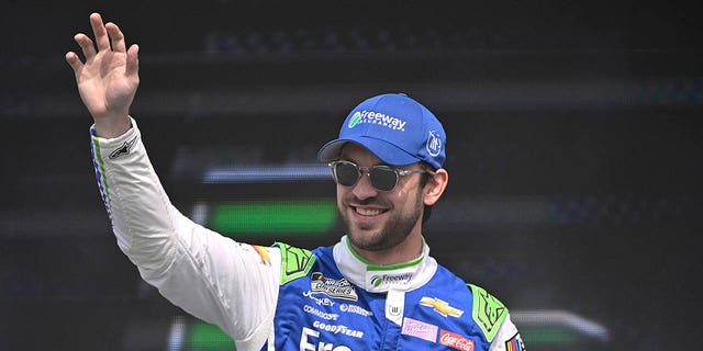 Daniel Suarez waves to fans as he takes the stage during driver introductions before the NASCAR Cup Series EchoPark Automotive Grand Prix on March 26, 2023 in Austin, Texas.