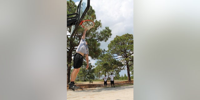 Daniel Prial loved playing basketball. He is seen here dunking the ball.