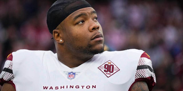 Daron Payne, #94 of the Washington Commanders, standing during the national anthem against the Houston Texans at NRG Stadium on November 20, 2022 in Houston.