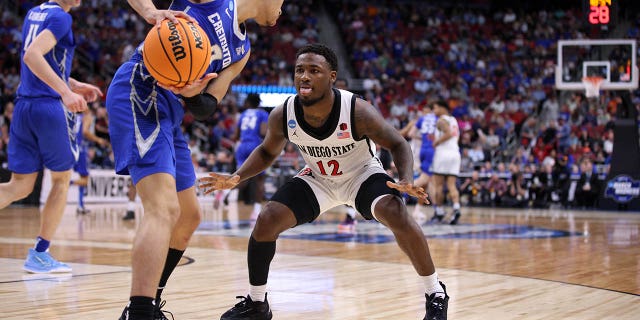 March 26, 2023;  Louisville, KY, USA;  Creighton Bluejays guard Ryan Nembhard (2) and San Diego State Aztecs guard Darrion Trammell (12) battle for the ball during the second half of the NCAA Tournament South Regional-Creighton vs San Diego State at KFC YUM!  Center.